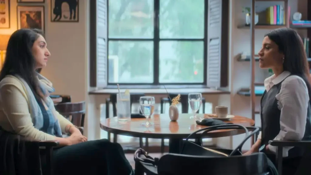 Two Indian women having a serious conversation at a cozy cafe table
