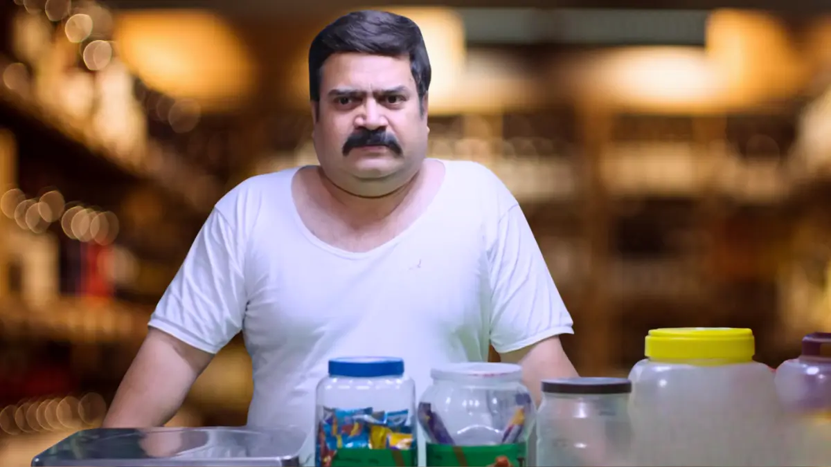 Family Kirana Store TVF series scene: Shopkeeper with mustache behind kirana counter with jars of snacks, small-town family drama