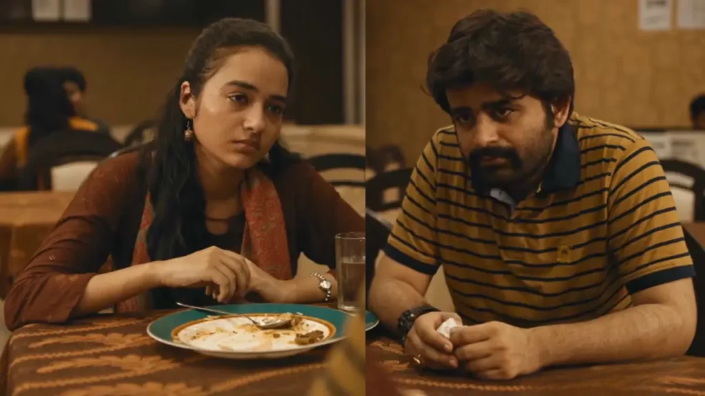 Indian woman and bearded man in serious discussion at restaurant table, woman with plate of food looking thoughtful, man holding napkin