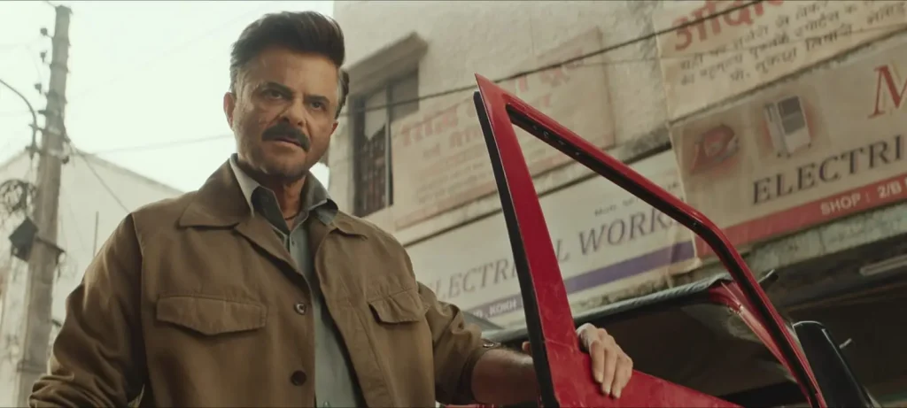 Subedar Movie Review: अनिल कपूर की 'सूबेदार' प्राइम वीडियो पर रिलीज, जानें कैसी है यह एक्शन थ्रिलर फिल्म? 3 Subedaar movie scene: Anil Kapoor as retired Subedaar Arjun Maurya by red car in small-town street, intense action drama look